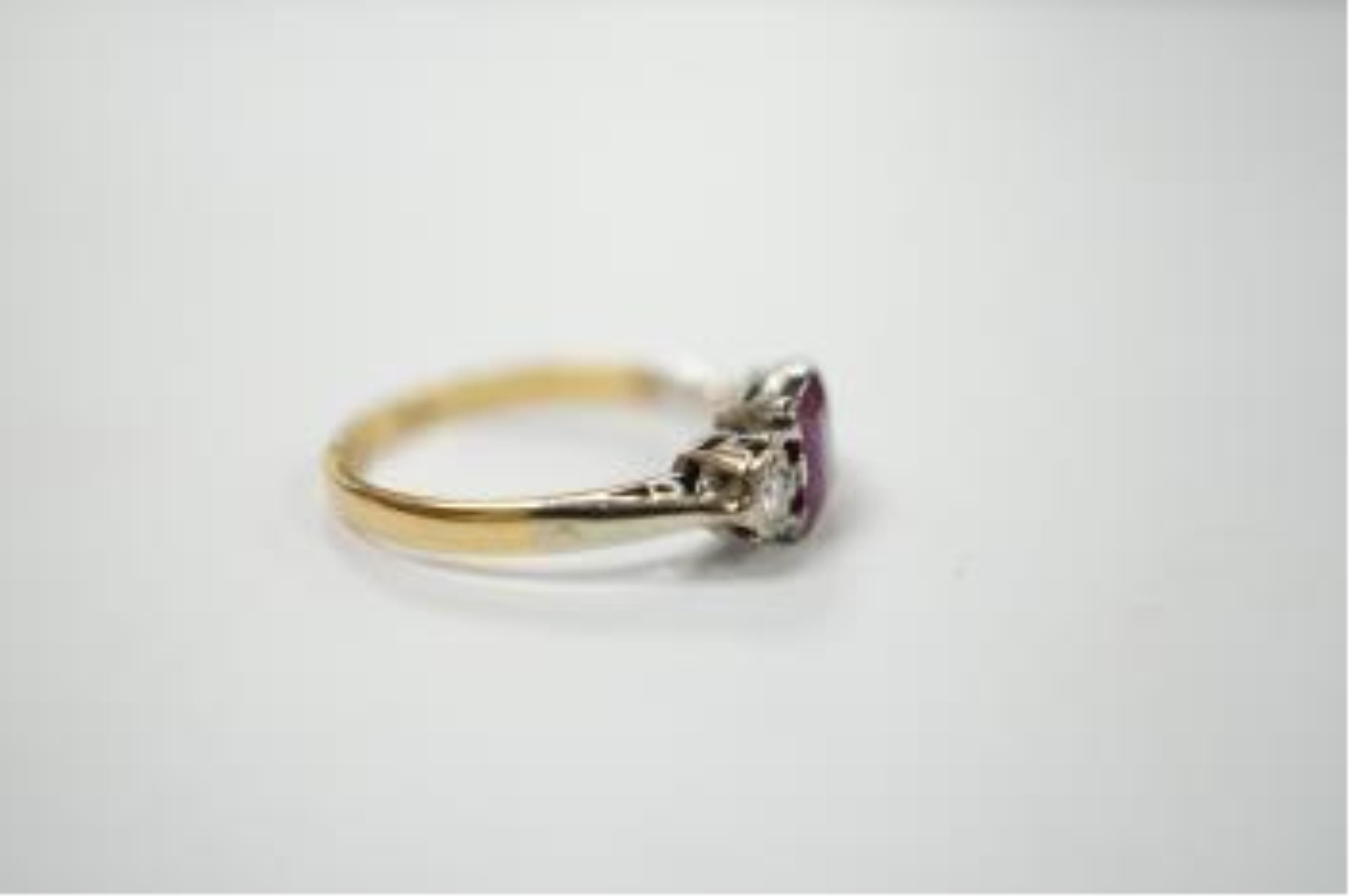 An 18ct & plat. ruby and diamond set three stone ring, size K, gross weight 2.3 grams. Condition - fair